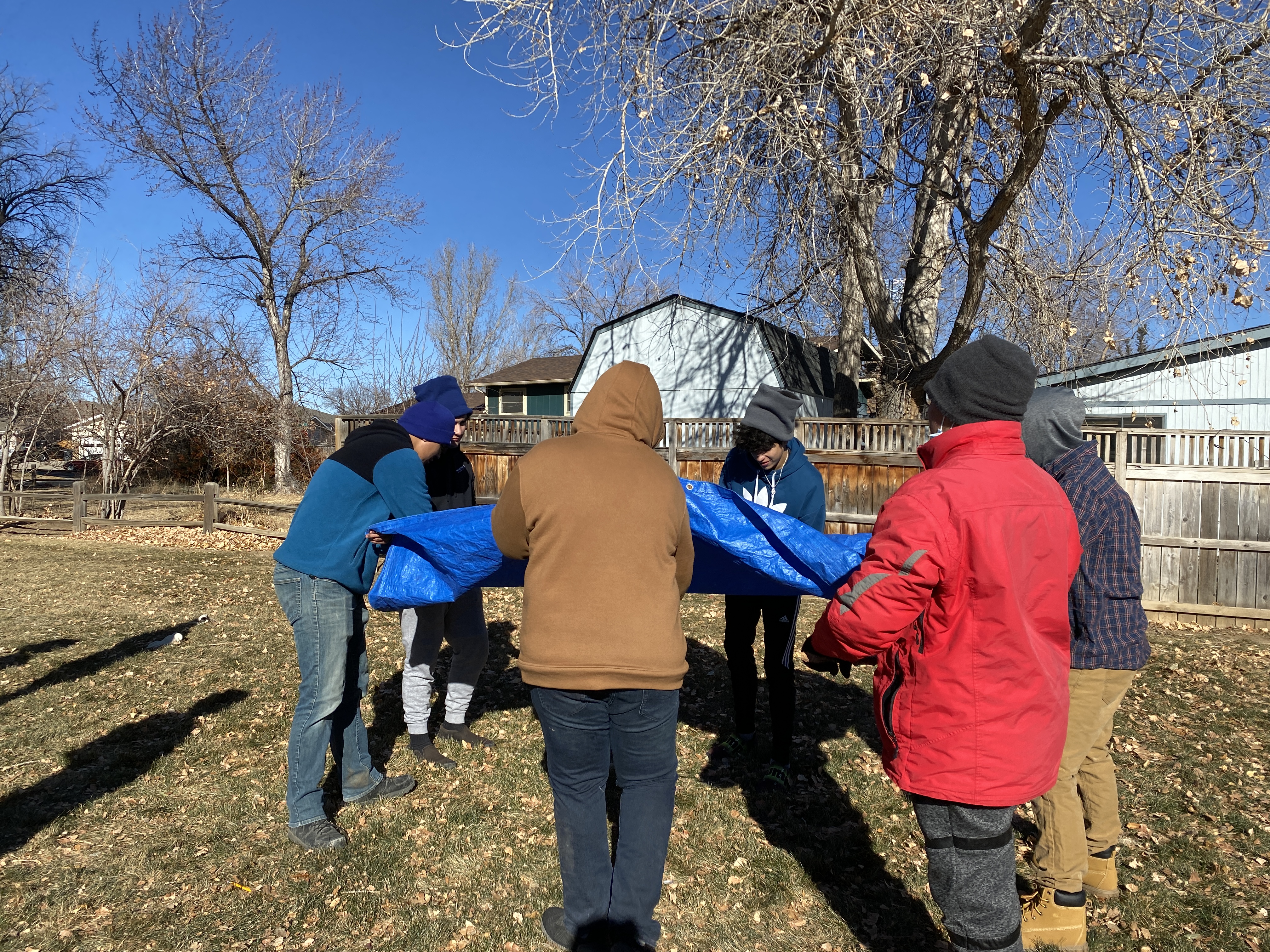 LYC interns try to flip the tarp at Cottonwood Park