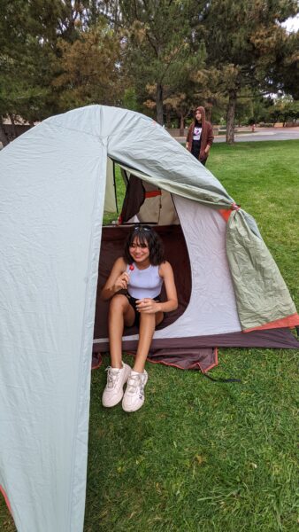 A Centaurus high school student sets up a tent in the school yard