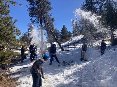 CHS students experience nature connection as they use shovels to build a quinzhee with snow.