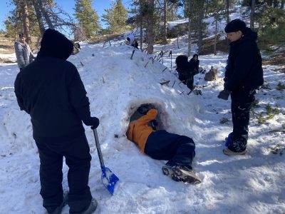 CHS students experience nature connection as they dig a tunnel through the quinzhee with shovels.
