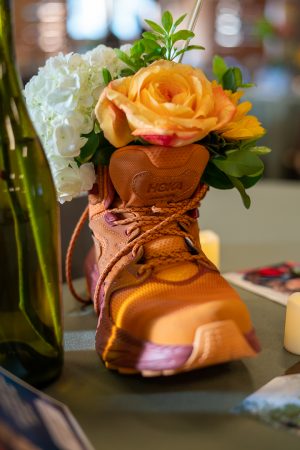 Bouquets of flowers in hiking boots were on display at the Base Camp Bash: Cheers to 20 Years event!