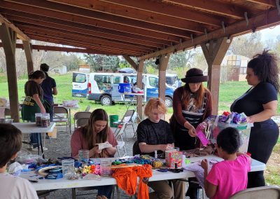 Attendees of the Ancestral Skills Gathering learn about mending clothes.