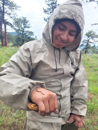 A downpour led to students enjoying worms on the trail. One is crawling on a student's hand here.