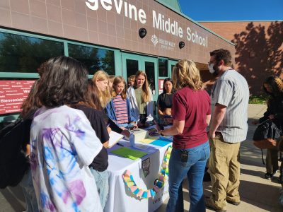 Angevine students sell baked goods at a table outside of school to raise funds for wildlife habitat restoration.