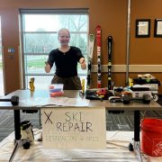 A Changemaker student displays tools for ski repair during the gear repair workshop.