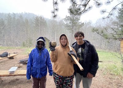 AXL students show off the "alpine apple" they found in the windy and snowy conditions at Cheley.