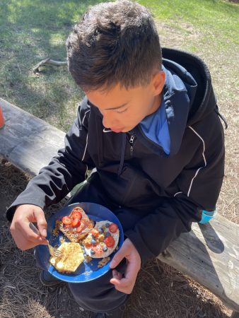 An AXL student displays breakfast on the windy and snowy overnight trip to Cheley.