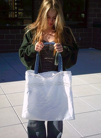 An NVHS student shows off an upcycled tote bag.