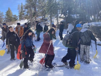 Centaurus High CAP students stomp snow for a snow shelter.