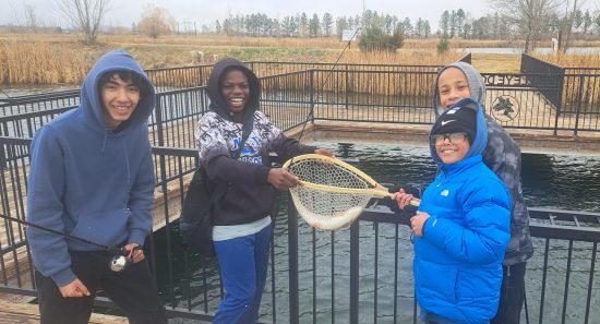 AXL students show off a fish they caught during their spring trimester in CAP class.