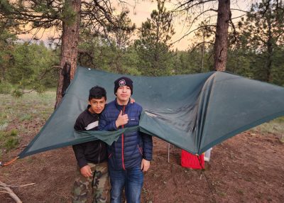 Casa teens show off their unique tarp shelter during their outdoor trip that involved intergenerational fun.