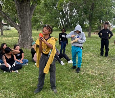 DMLK students put on a fashion show to showcase the 10 essentials of camping after learning about bear hangs.