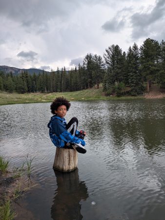 One student from Sims-Fayola takes a break from fishing to enjoy the peaceful atmosphere of the pond.