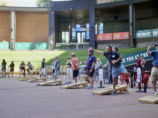 Participants throw bean bags at the 2025 Cottonwood Throwdown cornhole tournament.