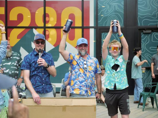 Some 2025 Cottonwood Throwdown winners show off their prizes high in the air.