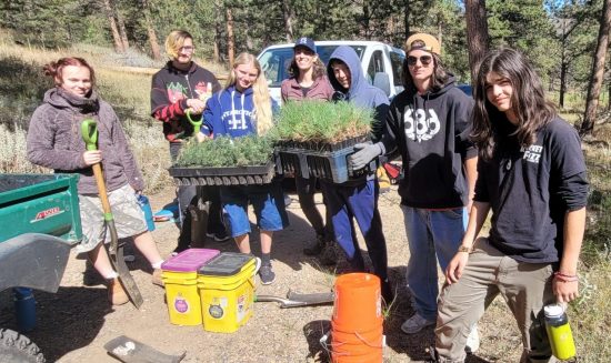 NVHS students pose with saplings at Cal-Wood. They spent several hours planting trees for wildfire restoration.