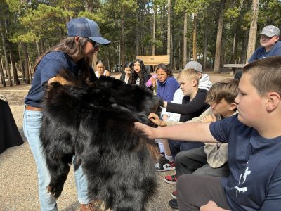 AXL students touch an animal skin during the Skulls and Skins presentation at Golden Gate Canyon State Park.
