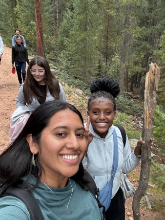 Ms. E and AXL 8th graders take a selfie while hiking to their climbing location.