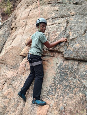 An AXL 8th grader gets vertical while rock climbing.