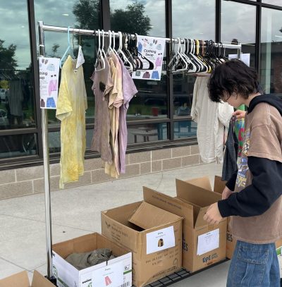 New Vista CAP students organize clothing that was recently donated to their clothing swap, due to the donuts for donations incentive.