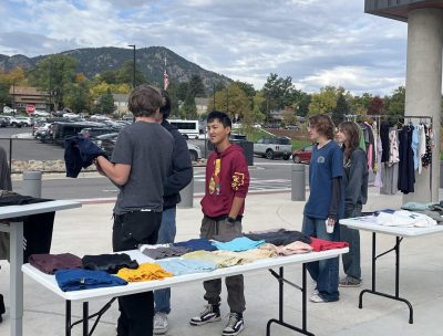 New Vista students browse the clothing on display at the outdoor swap organized by the CAP class.