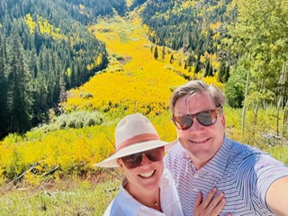 Cottonwood Board member Candace poses with her husband surrounded by fall colors.